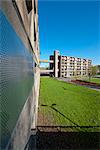 Detail view of steel security boarding on part of the derelict Park Hill Estate, Sheffield, with the block being redeveloped by Urban Splash in the distance. Architects: Jack Lynn and Ivor Smith