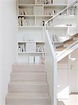 Interior view of Licht Activ Haus, The staircase and build-in bookshelf, Hamburg. Architects: Ostermann Architekton and Katarina Fey