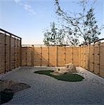 Minimalist gravel garden with fencing