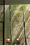 Bamboo in front of textured screen with pink flowers