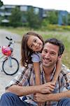 Daughter hugging father outdoors