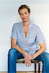 Mature woman sitting in chair, portrait