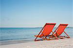 Empty deckchairs on beach