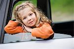 Little girl looking out of car window, portrait