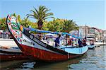 The crew prepares a colourful Moliceiro boat for a sightseeing tour along the canals of Aveiro, Beira Litoral, Portugal, Europe