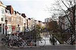 Looking along the Catharijnsingel, bicycles stand on a bridge over a canal in Utrecht, Utrecht Province, Netherlands, Europe