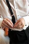 Groom Fastening Suspenders