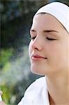 Woman spraying water on her face, inside