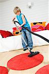Young boy with vacuum cleaner