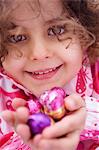 Little girl holding Easter eggs