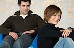 Smiling couple sitting in living-room