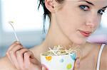 Portrait of a woman eating bean sprouts