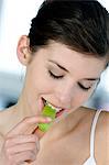 Portrait of a young woman eating apple slice