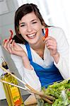 Portrait of a smiling woman making a salad