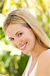 Portrait of a young woman looking at the camera, outdoors