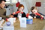 Ma annonce deux enfants assis autour de table, échange de Noël présente, à l'intérieur