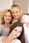 Three smiling women, indoors