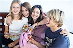 Portrait of a mother and her three children teenagers, indoors