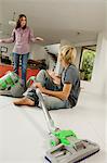 Mother and son in living room, vacuum cleaner, indoors