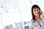 Portrait of a smiling woman phoning, holding white balloons