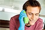 Portrait of a man making a phone call with a sponge