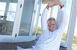 Man stretching on wooden terrace