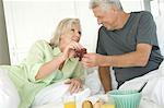 Couple having breakfast in bed