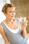 Senior woman holding glass of water