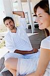 Couple sitting on wooden terrace