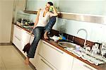 Young woman looking tired, in kitchen