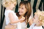 Mother and 2 children on a swing chair