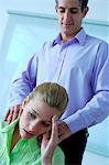 Businessman massaging businesswoman in office