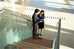 High angle view of a businessman and a businesswoman looking at a diary