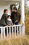 Girl with her parents smiling in a balcony