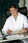 Portrait of a male doctor sitting at a desk in his office