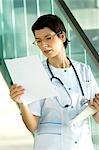 Female doctor reading medical records
