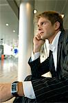 Side profile of a businessman sitting at an airport lounge