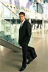 Portrait of a businessman carrying a luggage at an airport