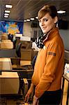 Portrait of a female airline check-in attendant at an airport check-in counter