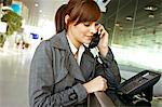 Close-up of a businesswoman talking on the telephone at an airport