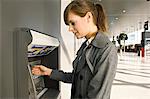 Side profile of a businesswoman using an ATM