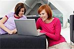 Two young women using a laptop