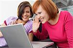 Two young women using a laptop