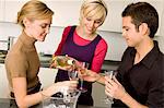 Young woman pouring wine for her friends