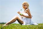 Young woman eating vegetables