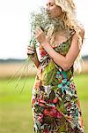 Young woman holding bunch of flowers