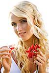 Young woman holding a red gerbera