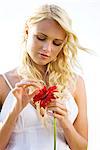 Young woman holding a red flower