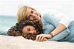 Teenage boy and a girl relaxing on the beach