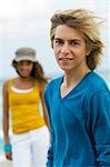 Teenage boy standing with a girl on the beach